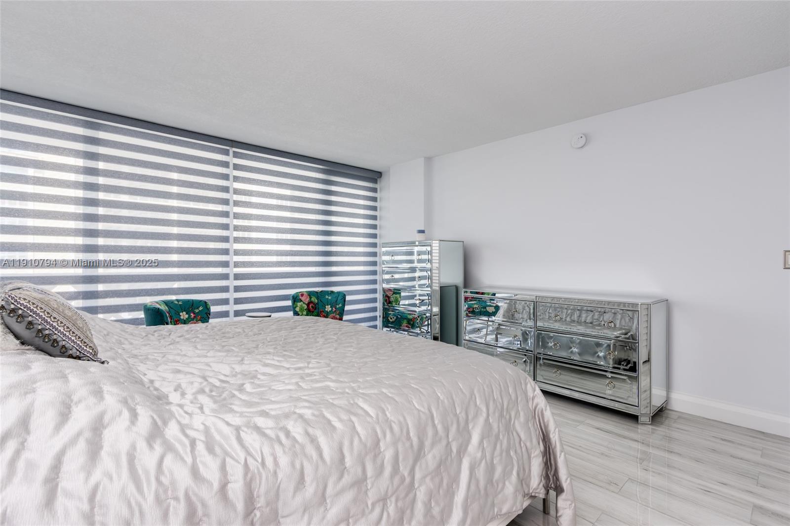 1200 South Ocean Boulevard, Unit 9F Boca Raton, FL 33432 - Photo 18 of 55 a bedroom with a large bed and a night stand