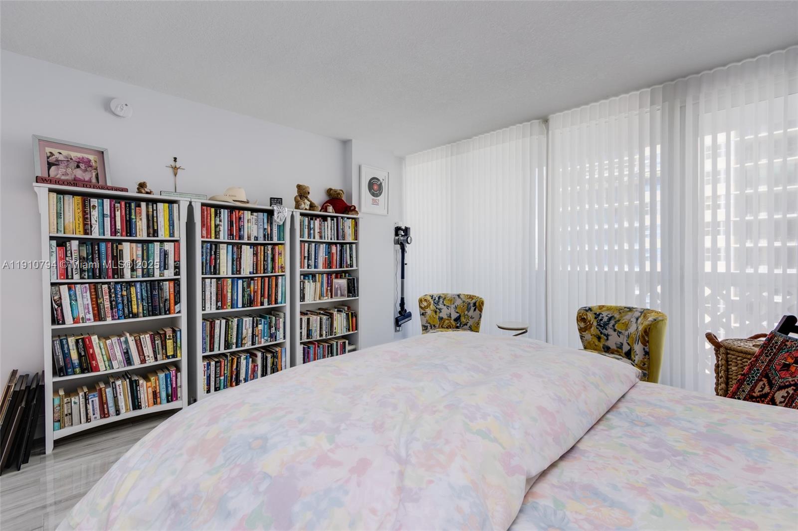 1200 South Ocean Boulevard, Unit 9F Boca Raton, FL 33432 - Photo 24 of 55 a bedroom with a bed a book shelf and a book shelf