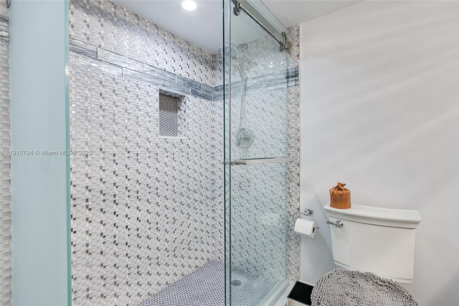 1200 South Ocean Boulevard, Unit 9F Boca Raton, FL 33432 - Photo 25 of 55 a bathroom with a toilet and a shower