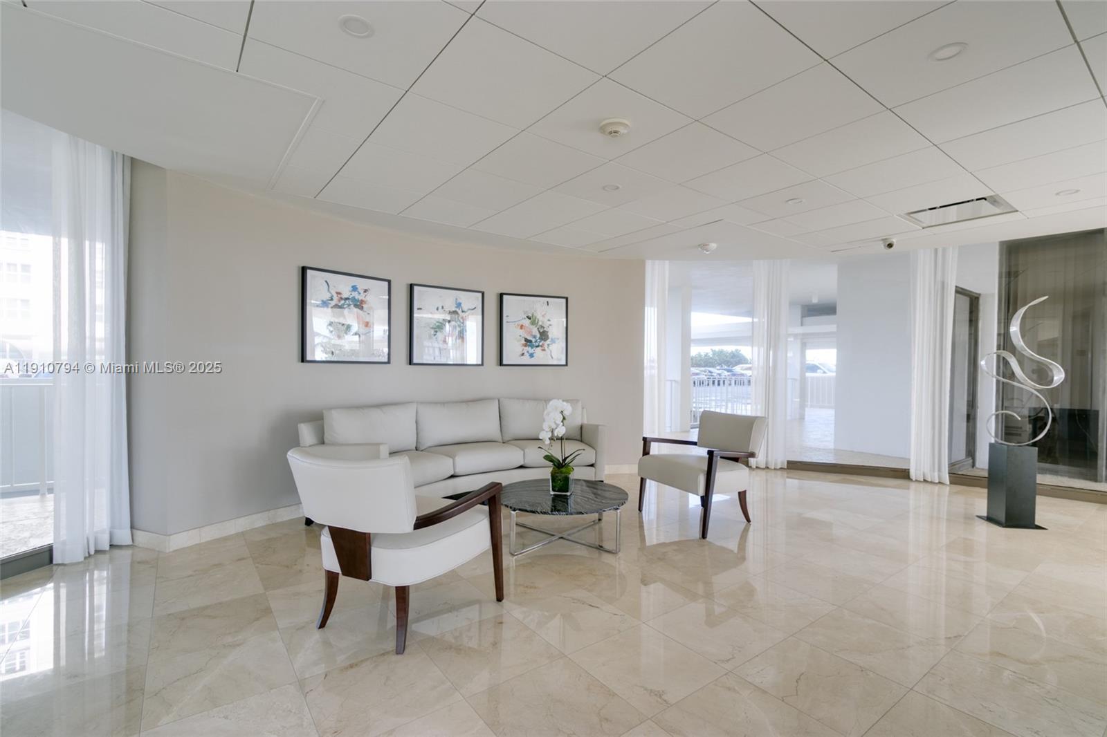 1200 South Ocean Boulevard, Unit 9F Boca Raton, FL 33432 - Photo 46 of 55 a living room with furniture and a table