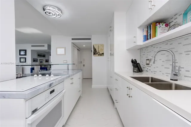 a kitchen with a sink and a refrigerator
