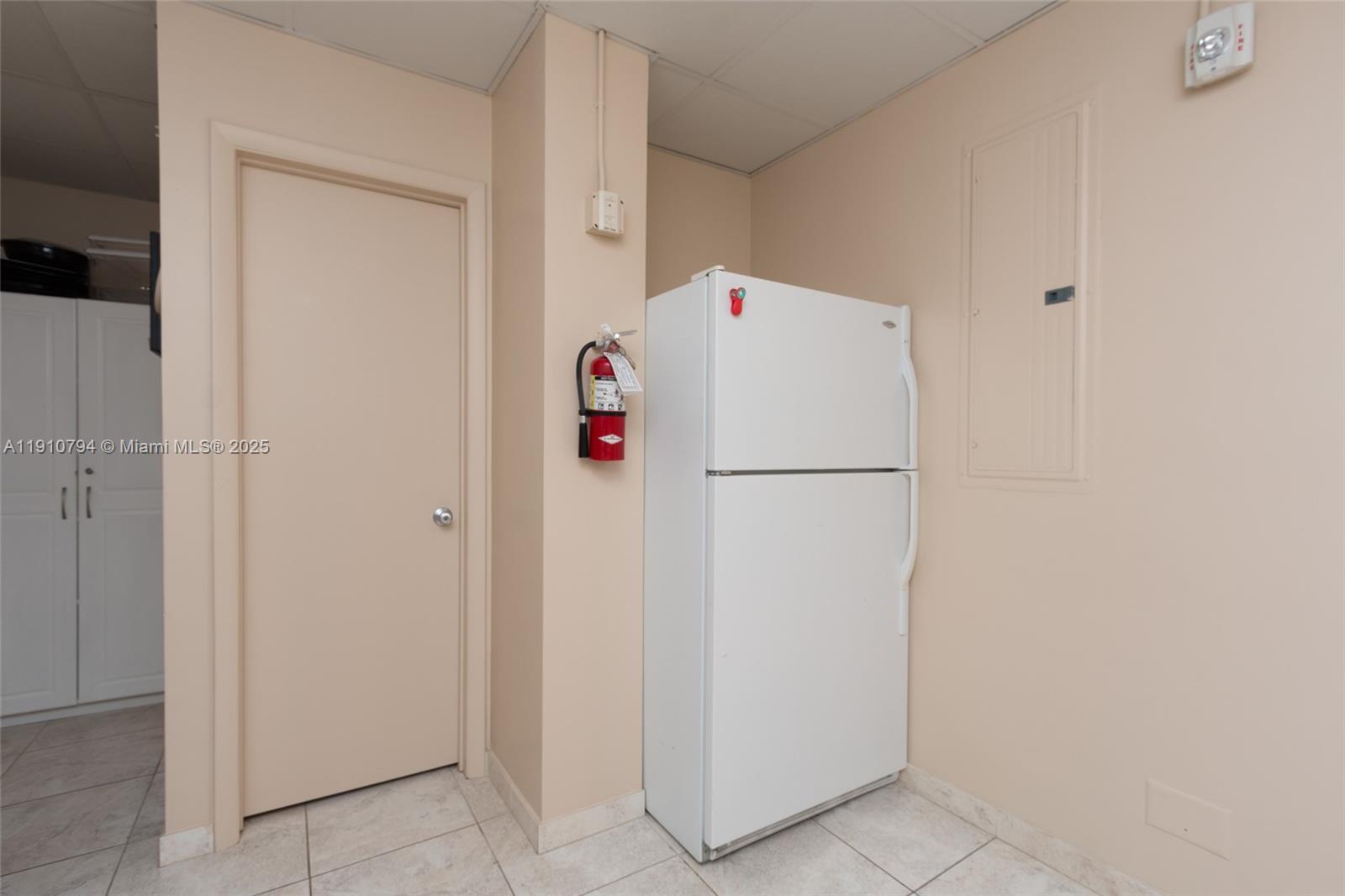 1200 South Ocean Boulevard, Unit 9F Boca Raton, FL 33432 - Photo 54 of 55 a white refrigerator freezer sitting inside of a kitchen