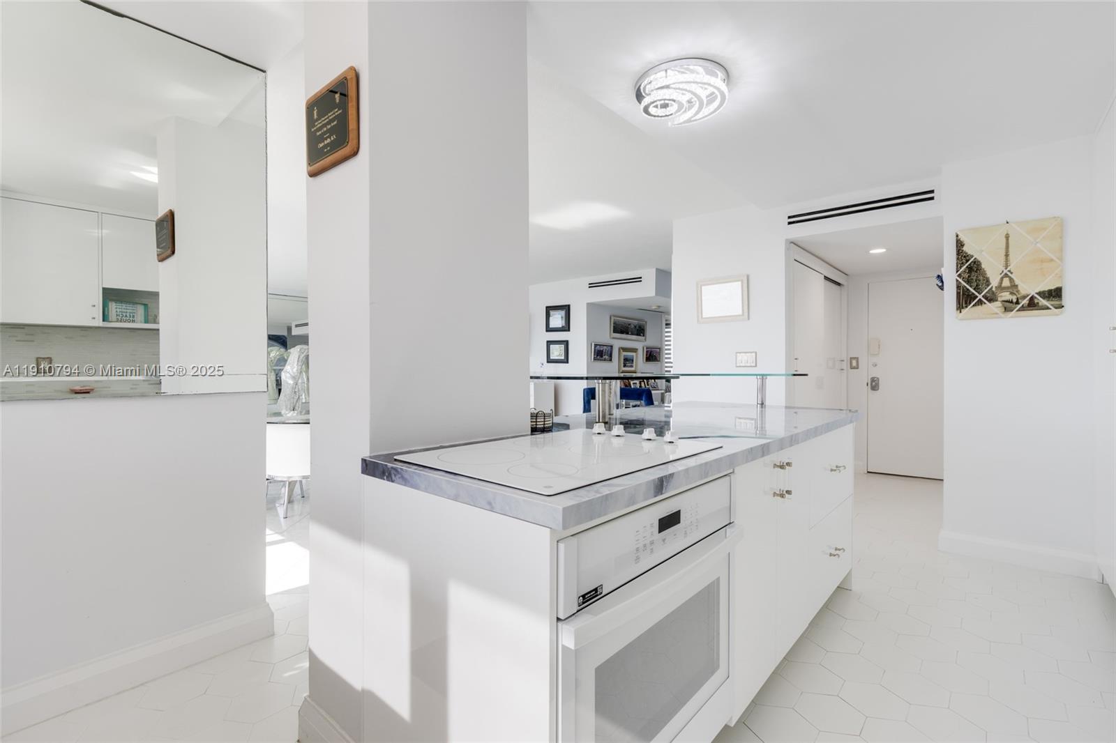1200 South Ocean Boulevard, Unit 9F Boca Raton, FL 33432 - Photo 7 of 55 a kitchen with a sink and a refrigerator