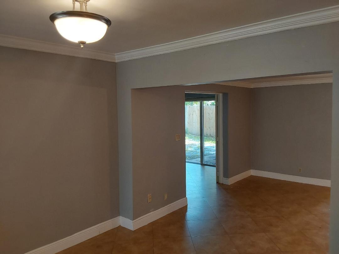 98 Seminole Lane Boca Raton, FL 33487 - Photo 31 of 42 an empty room with wooden floor and windows