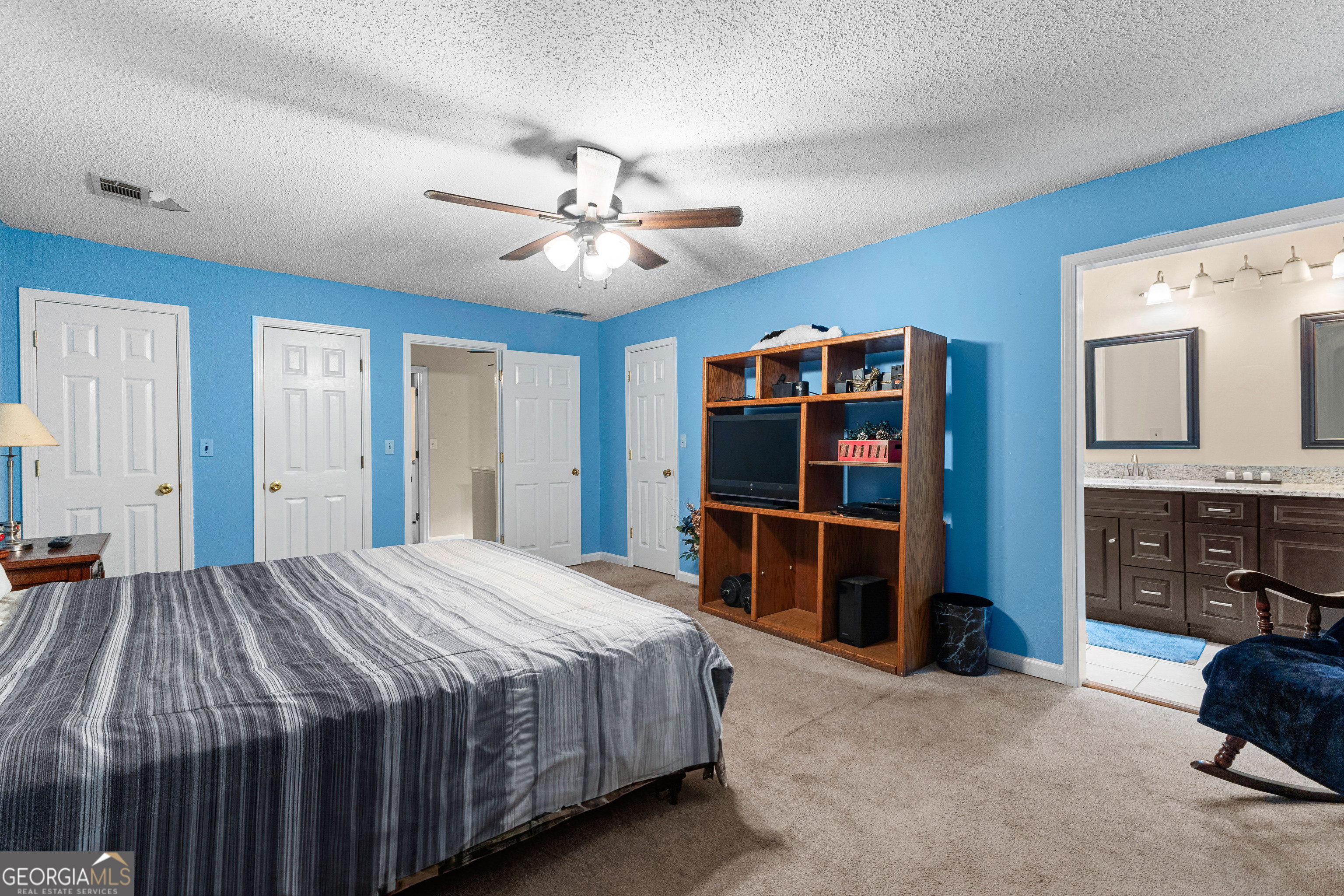 145 Greison Trail Newnan, GA 30263 - Photo 16 of 28 a bedroom with a bed and a dresser