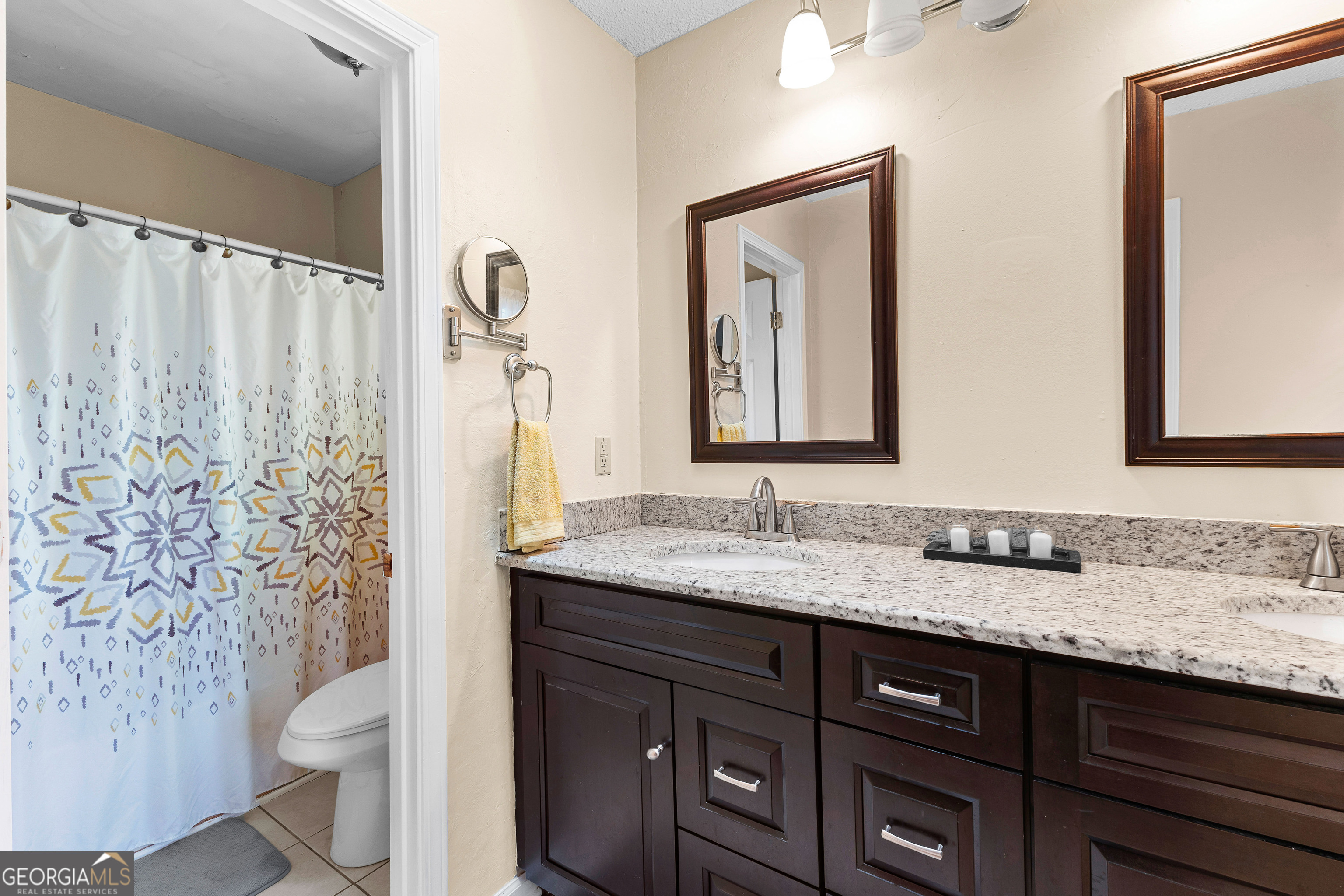 145 Greison Trail Newnan, GA 30263 - Photo 18 of 28 a bathroom with a granite countertop sink toilet and mirror