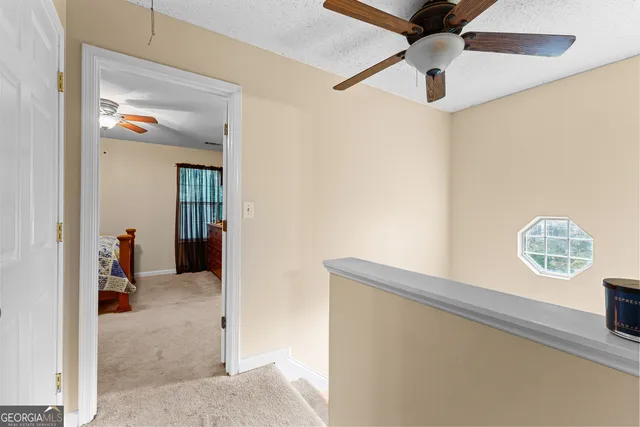 an entryway with a chandelier fan