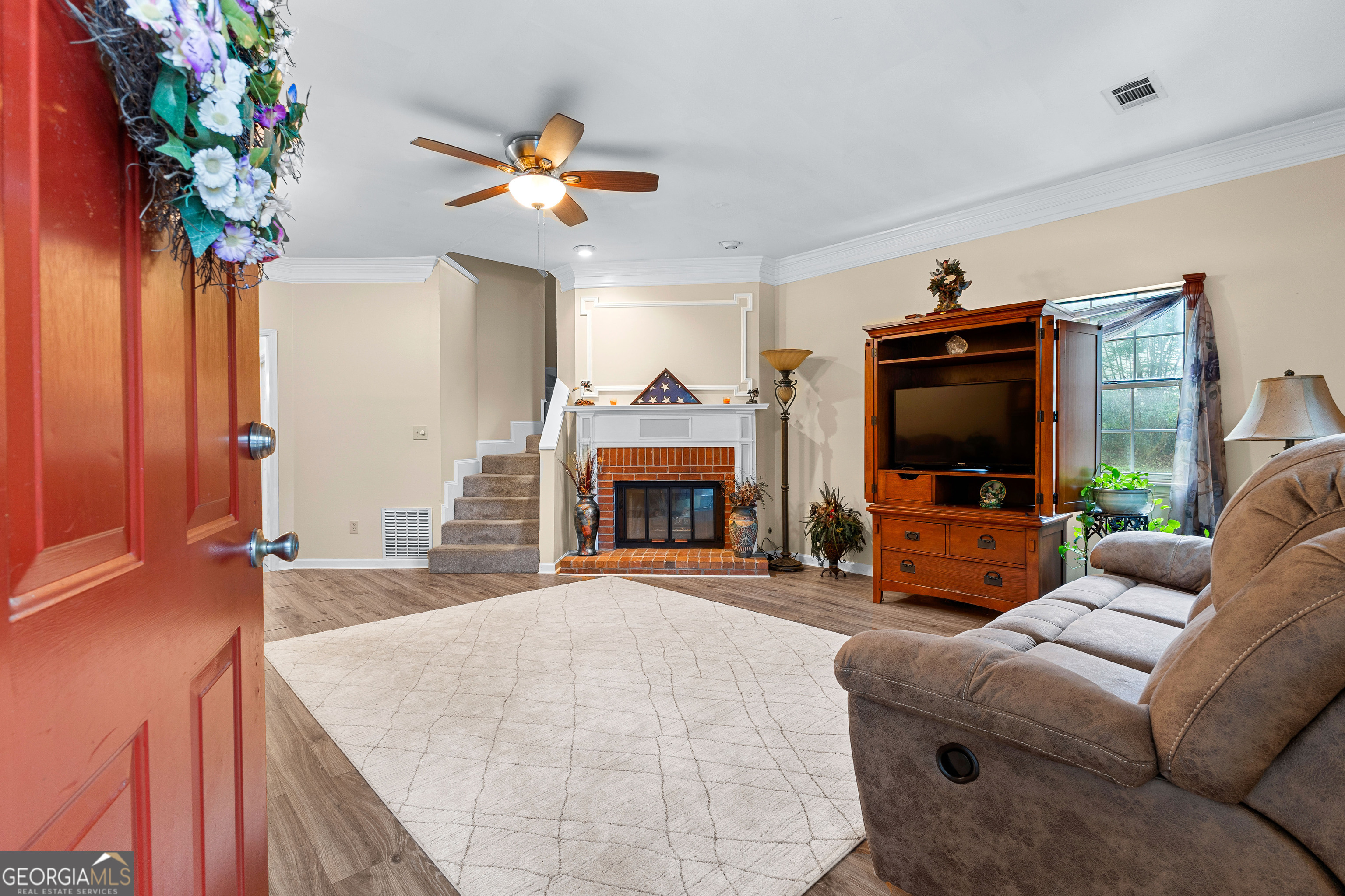 145 Greison Trail Newnan, GA 30263 - Photo 2 of 28 a living room with furniture and a flat screen tv