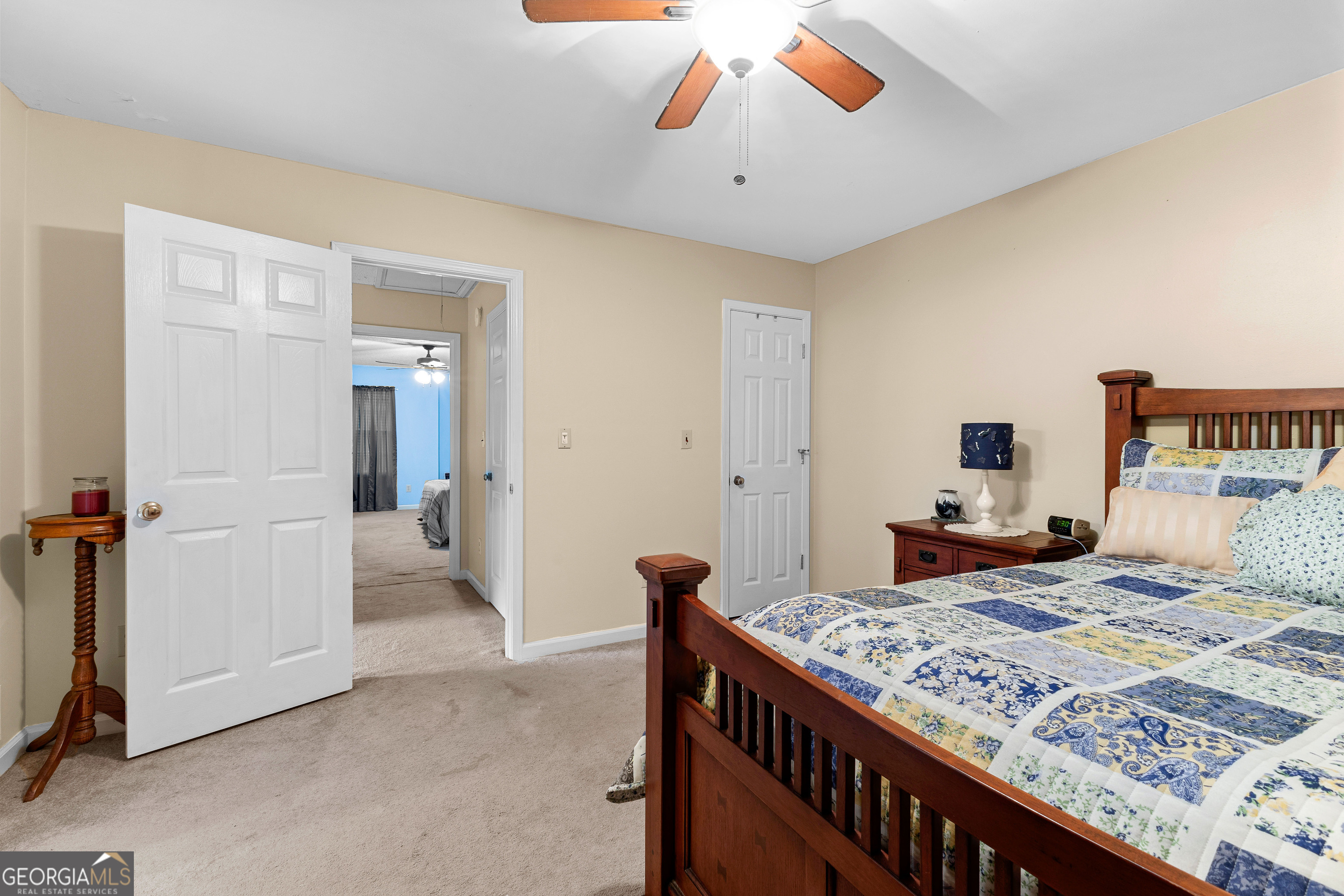 145 Greison Trail Newnan, GA 30263 - Photo 22 of 28 a bedroom with a bed and a chandelier