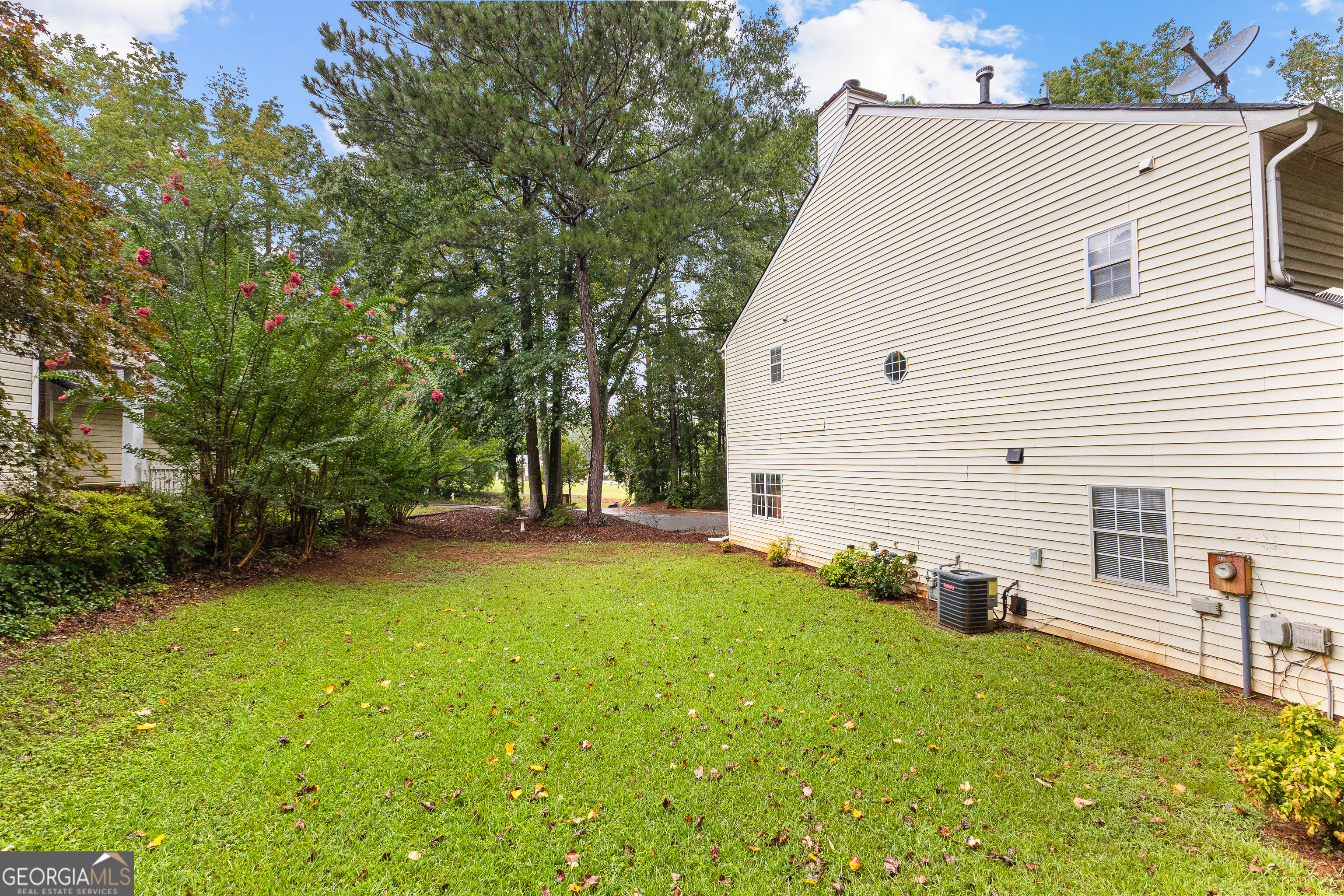 145 Greison Trail Newnan, GA 30263 - Photo 28 of 28 a view of a backyard with table and chairs and a large tree
