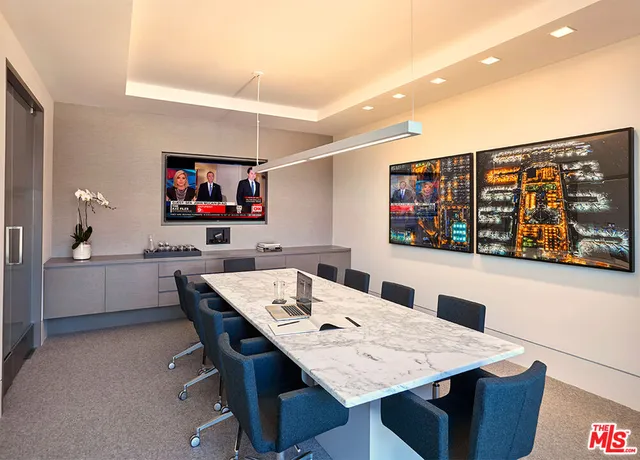 a view of a projector room with furniture and screen tv