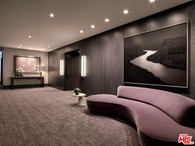 a lobby with a couch and a projector screen