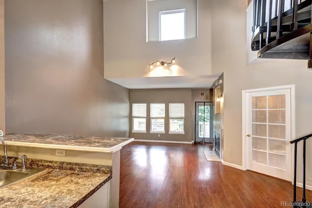 a view of a kitchen with wooden floor and a window