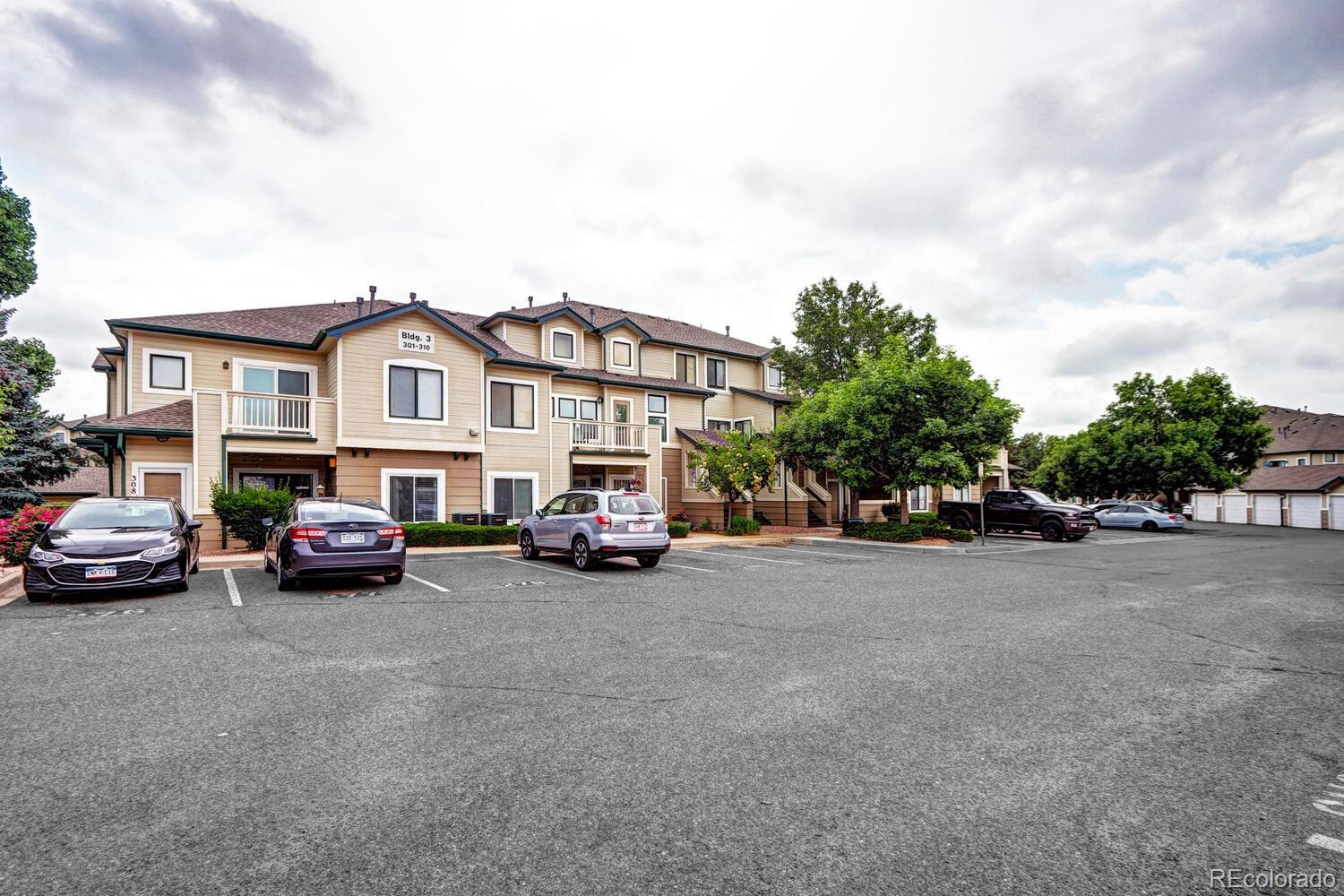 8707 East Florida Avenue, Unit 304 Denver, CO 80247 - Photo 2 of 26 a view of a cars is parked in front of a house