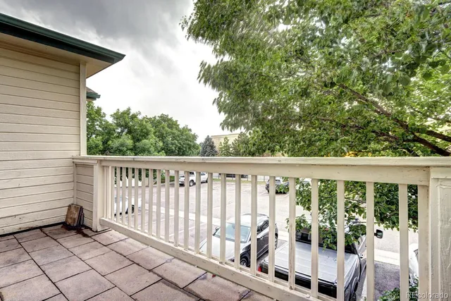 a view of a balcony with wooden floor