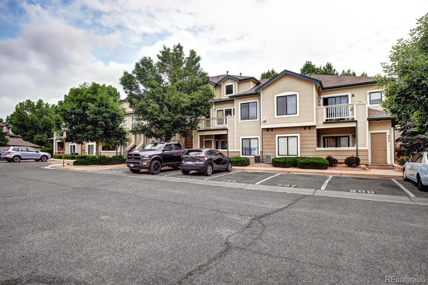 8707 East Florida Avenue, Unit 304 Denver, CO 80247 - Photo 3 of 26 a view of a car parked in front of a house