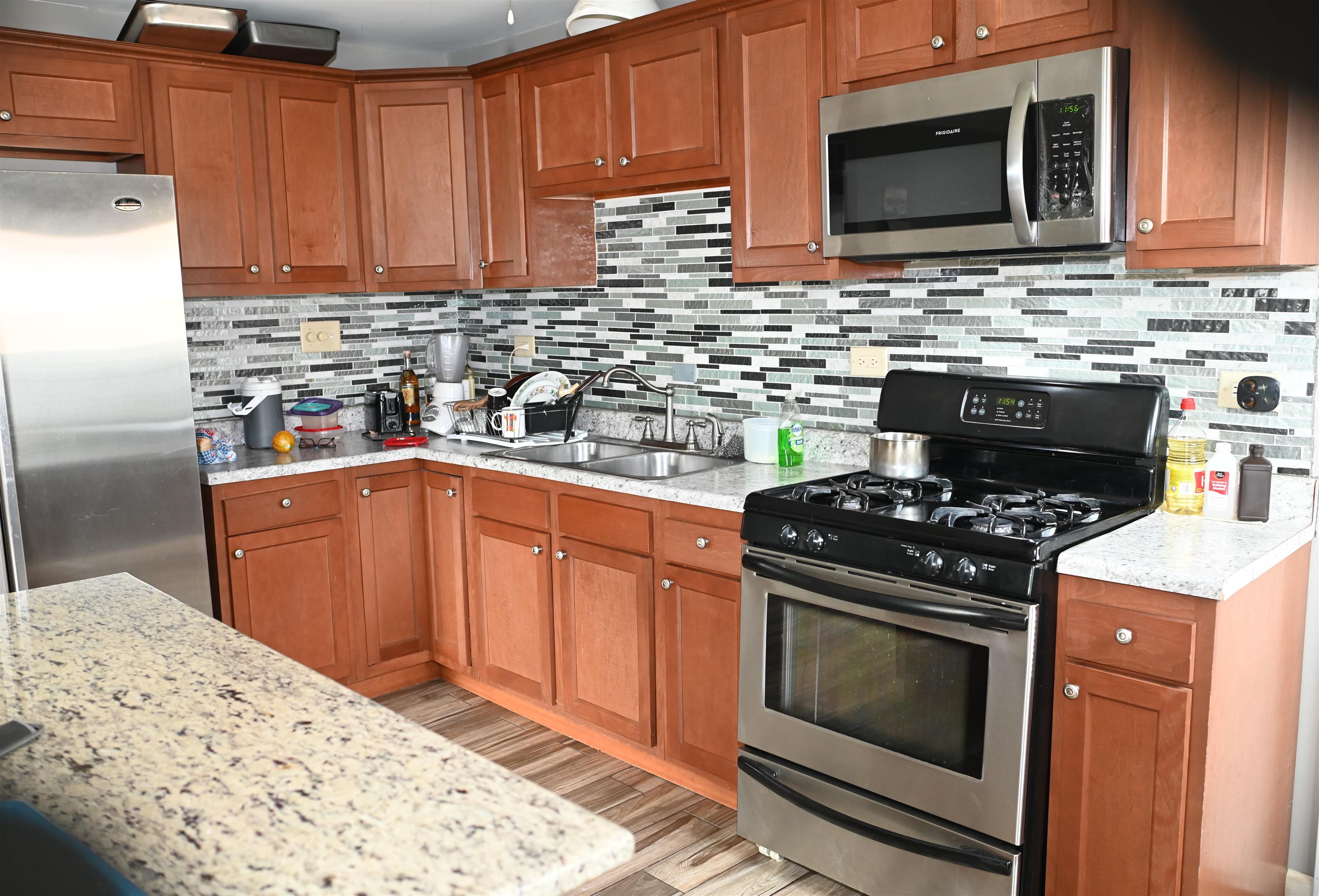 177 West Briarcliff Road Bolingbrook, IL 60440 - Photo 5 of 20 a kitchen with stainless steel appliances a stove a microwave sink and cabinets