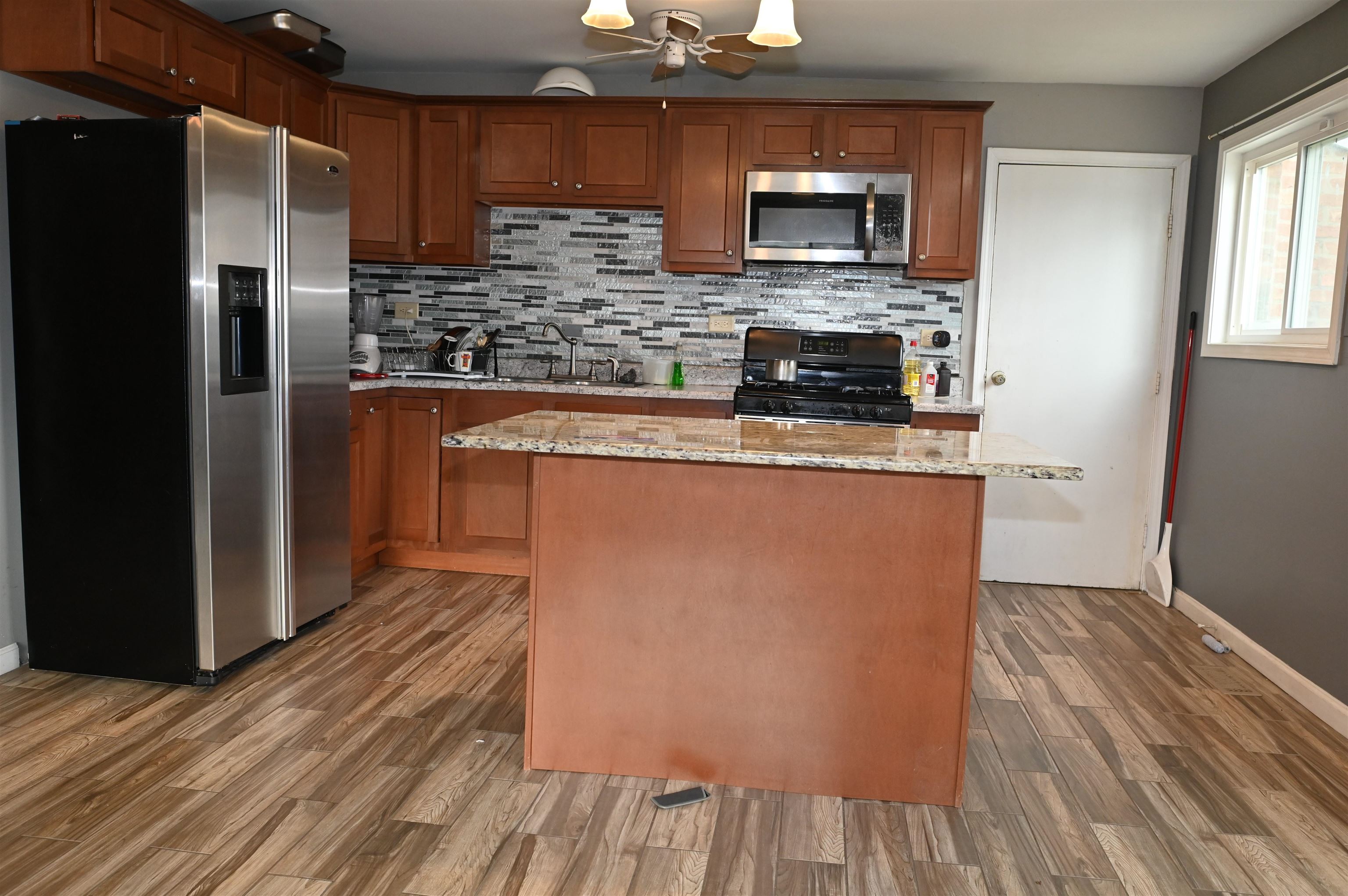 177 West Briarcliff Road Bolingbrook, IL 60440 - Photo 6 of 20 a kitchen with stainless steel appliances granite countertop a refrigerator a stove top oven a sink and dishwasher