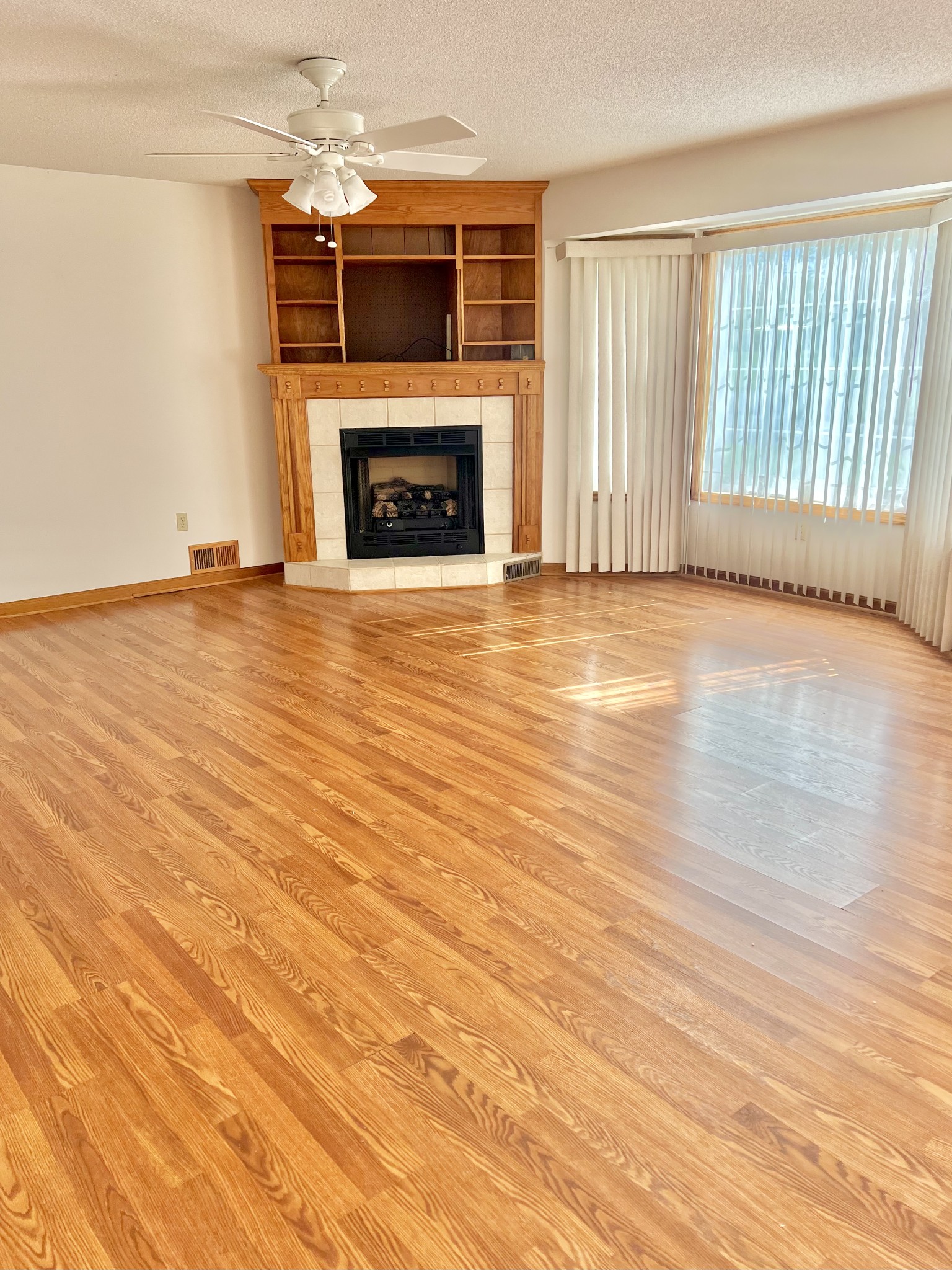 1601 Ann Road Lawrenceburg, TN 38464 - Photo 18 of 30 an empty room with wooden floor fireplace and windows