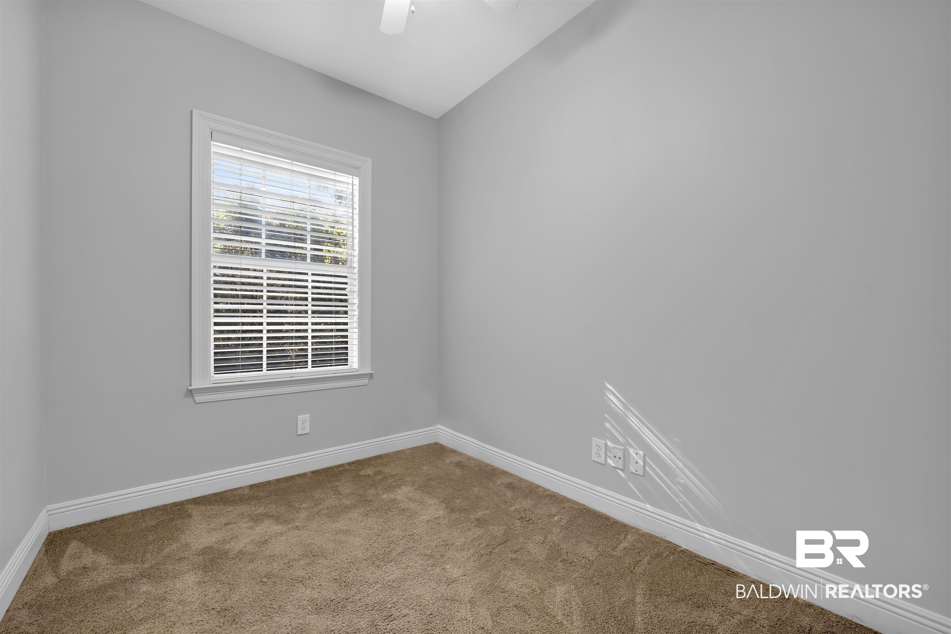 1262 Patrick Street Daphne, AL 36526 - Photo 14 of 35 Carpeted empty room featuring baseboards and ceiling fan