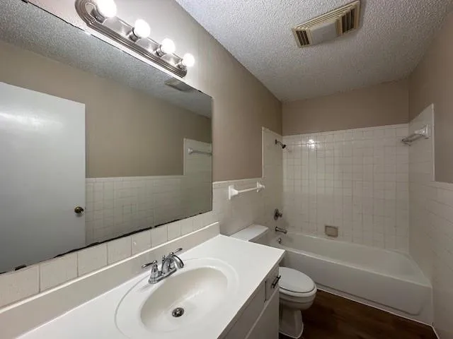 a bathroom with a sink mirror toilet and shower