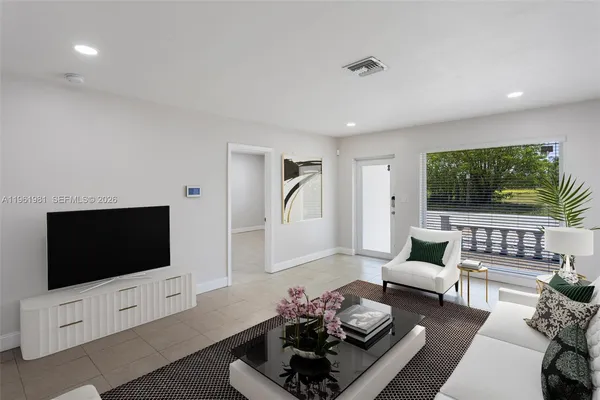 a living room with furniture and a flat screen tv