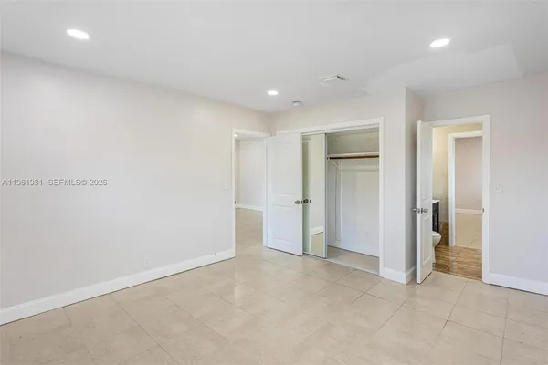 an empty room with closet area