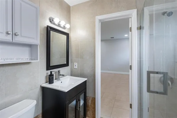 a bathroom with a toilet sink shower and mirror