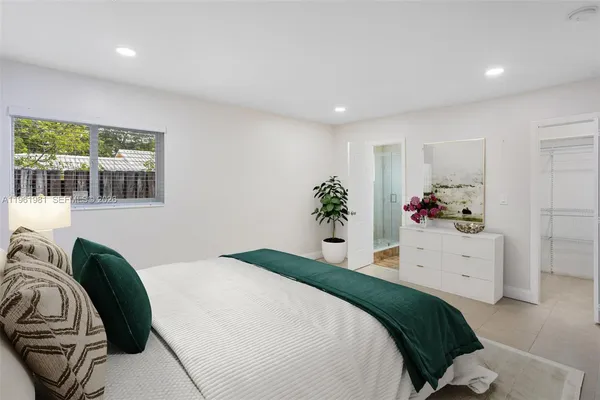 a bedroom with a bed and a window