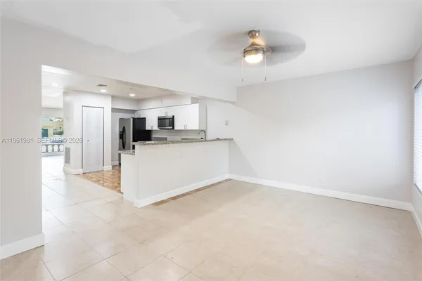 a view of a kitchen with a sink and cabinets