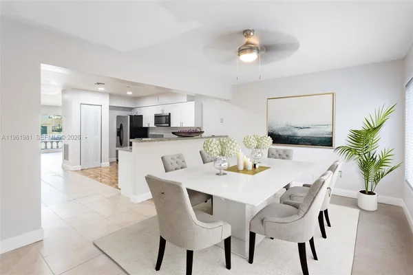 a dining room with furniture and a kitchen view