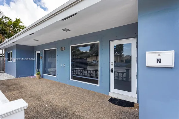a view of a house with a potted plant and a window