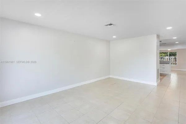an empty room with wooden floor