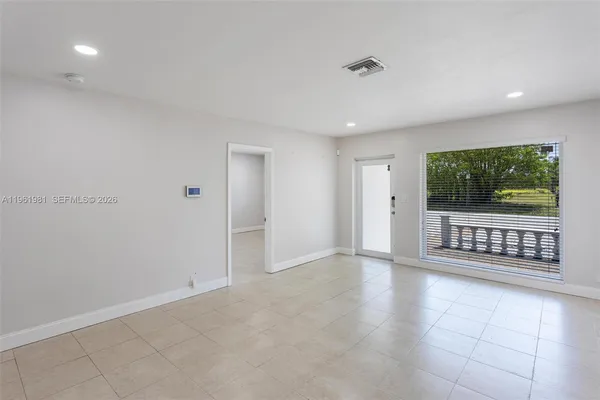 a view of an empty room with a window
