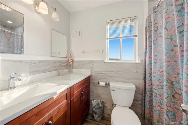 a bathroom with a toilet sink and mirror