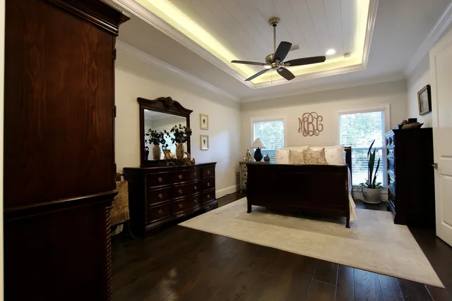 a living room with wooden floor and furniture