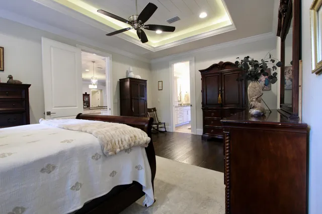 a spacious bedroom with a bed and a chandelier