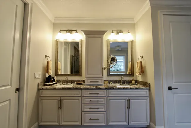 a bathroom with a granite countertop sink and a mirror