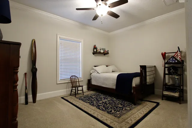 a bedroom with a bed and a chandelier