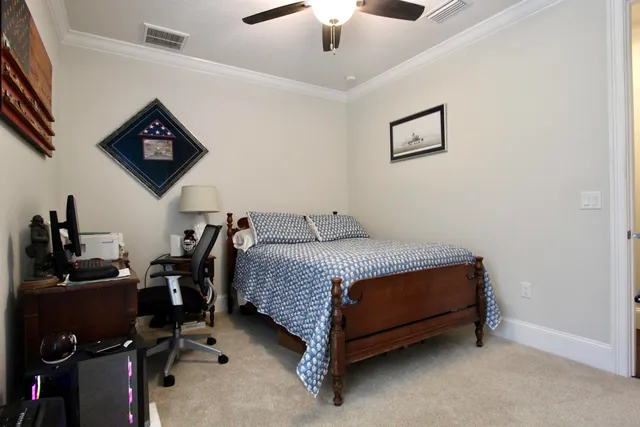 a bed room with a bed and a ceiling fan
