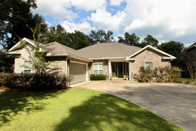 a front view of a house with a garden and pathway