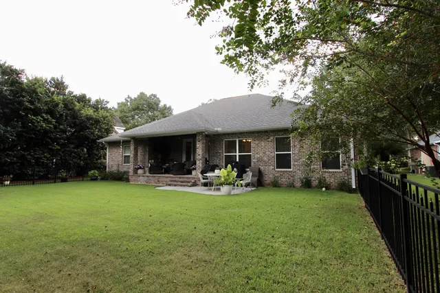 a view of a house with backyard porch and garden
