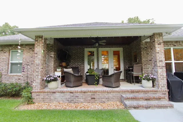 a view of a house with potted plants