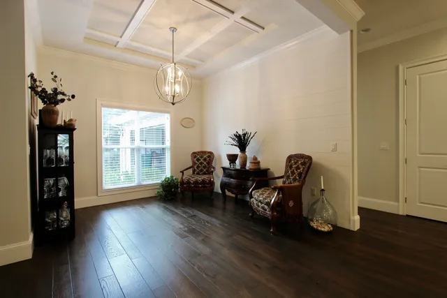 a view of a room with wooden floor furniture and windows