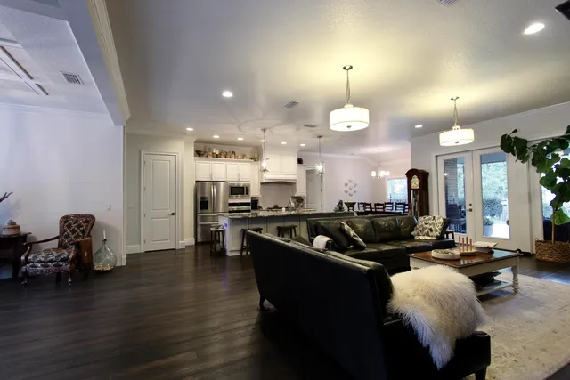 a kitchen with granite countertop a stove and white cabinets