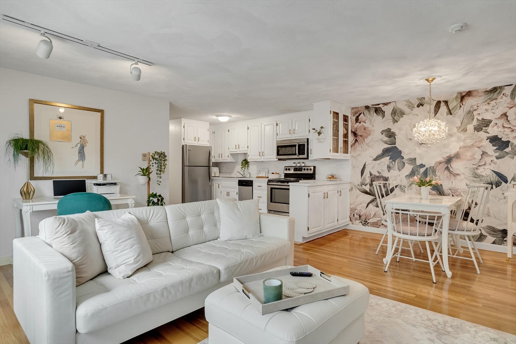 71 Stone Street, Unit 5 Walpole, MA 02081 - Photo 1 of 18 a living room with furniture and kitchen view