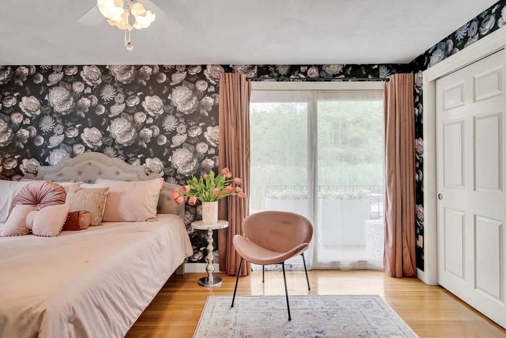 71 Stone Street, Unit 5 Walpole, MA 02081 - Photo 11 of 18 a bedroom with a bed lamp and a potted plant