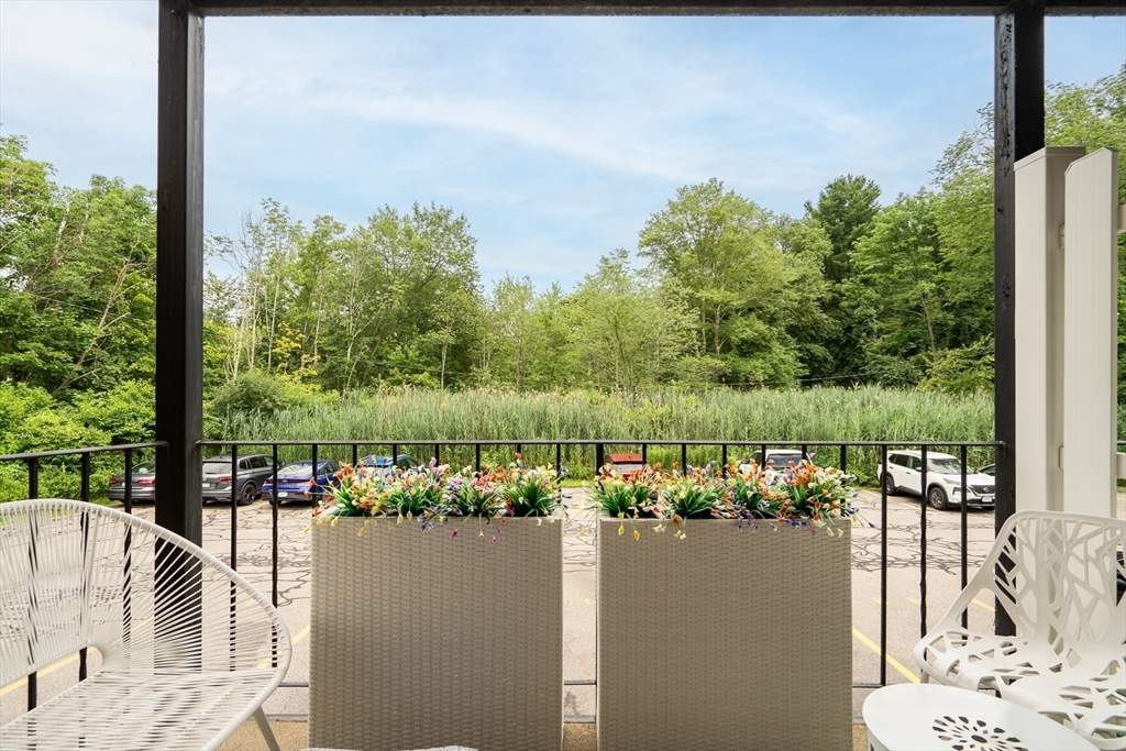 71 Stone Street, Unit 5 Walpole, MA 02081 - Photo 12 of 18 a view of a lake from a balcony