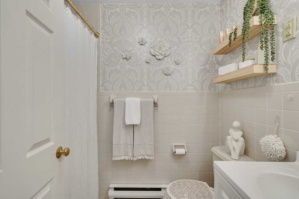 71 Stone Street, Unit 5 Walpole, MA 02081 - Photo 13 of 18 a bathroom with a bathtub and shower