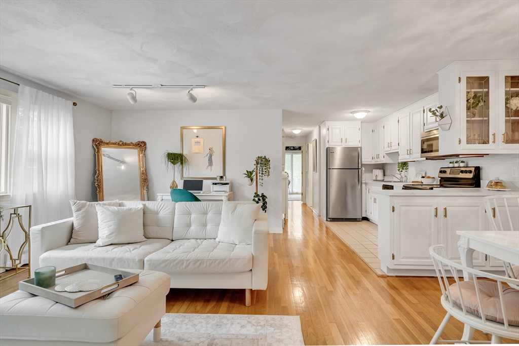 71 Stone Street, Unit 5 Walpole, MA 02081 - Photo 2 of 18 a living room with furniture and kitchen view